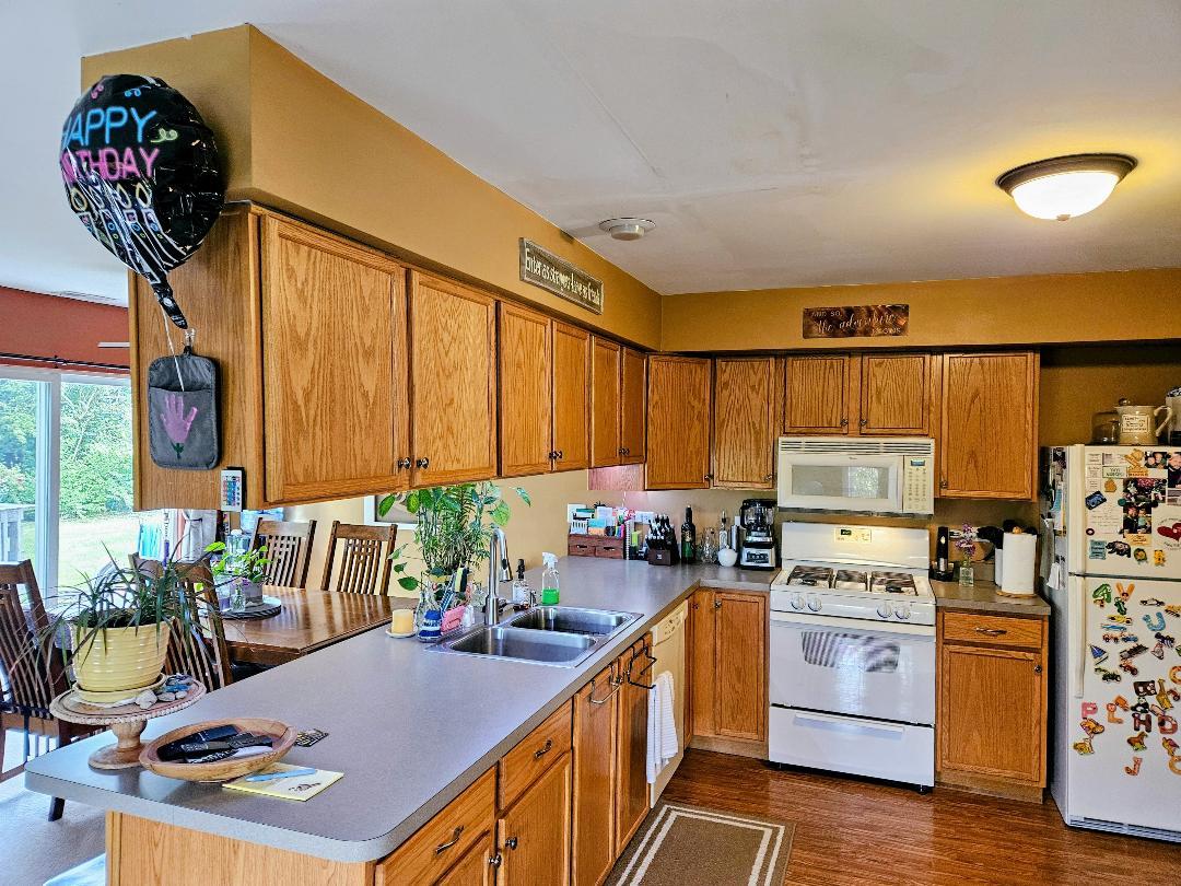 25159 Faraday Road Manhattan, IL 60442 - Photo 11 of 28 a kitchen that has a lot of cabinets a sink and a stove in it