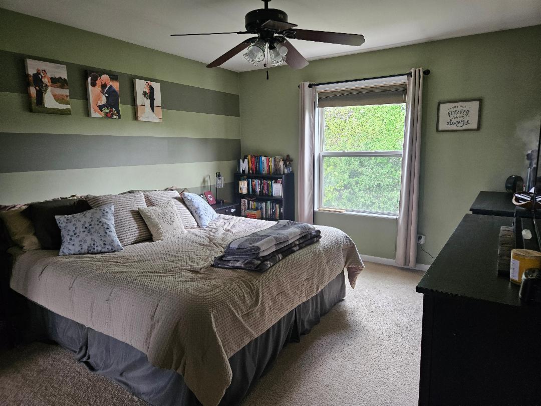 25159 Faraday Road Manhattan, IL 60442 - Photo 15 of 28 a bedroom with a bed and a chandelier