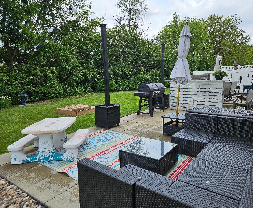 25159 Faraday Road Manhattan, IL 60442 - Photo 25 of 28 a view of a patio with table and chairs potted plants with wooden floor and fence