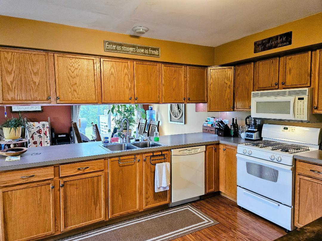 25159 Faraday Road Manhattan, IL 60442 - Photo 8 of 28 a kitchen with stainless steel appliances granite countertop a sink a stove cabinets and a window