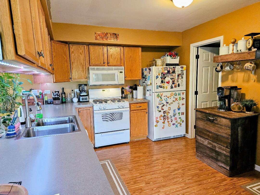 25159 Faraday Road Manhattan, IL 60442 - Photo 10 of 28 a kitchen with stainless steel appliances granite countertop a stove a sink and a refrigerator
