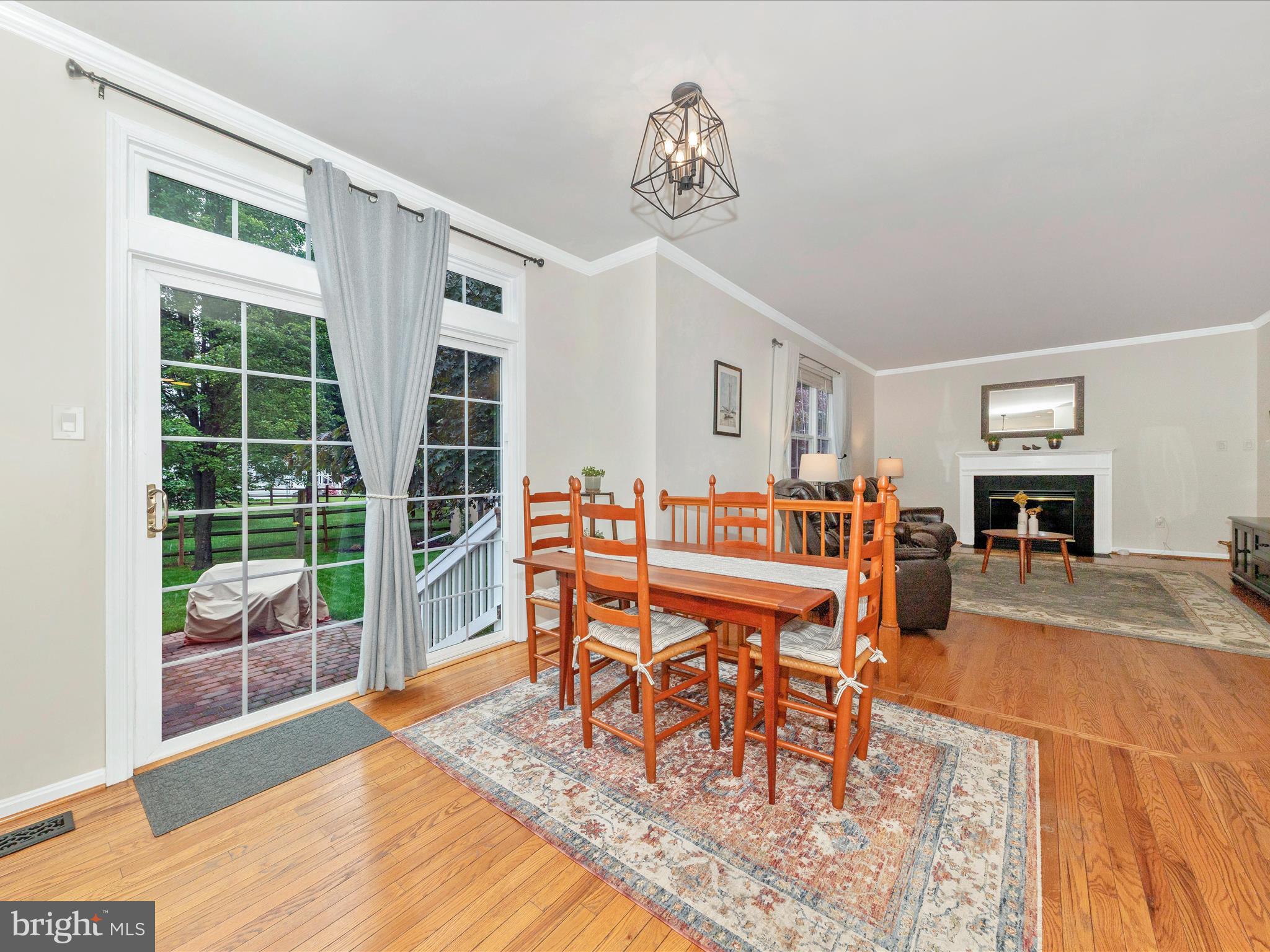 9034 Allington Manor Circle West Frederick, MD 21703 - Photo 11 of 55 a dining room with furniture a rug and wooden floor