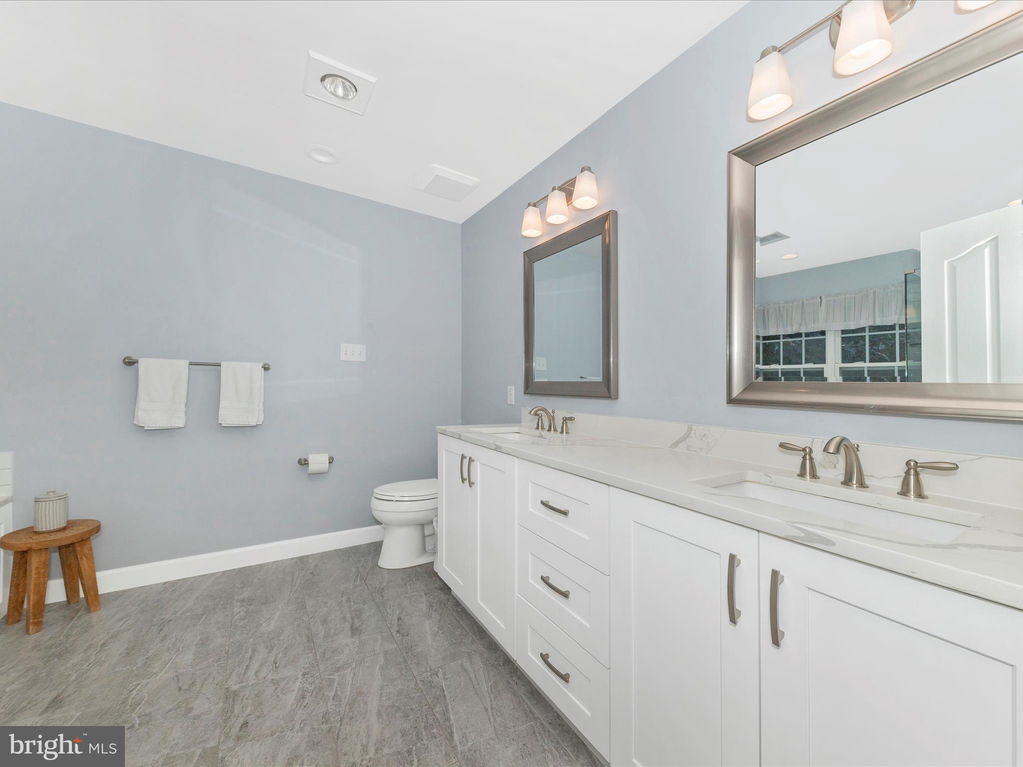 9034 Allington Manor Circle West Frederick, MD 21703 - Photo 21 of 55 a spacious bathroom with a double vanity sink a toilet and a mirror