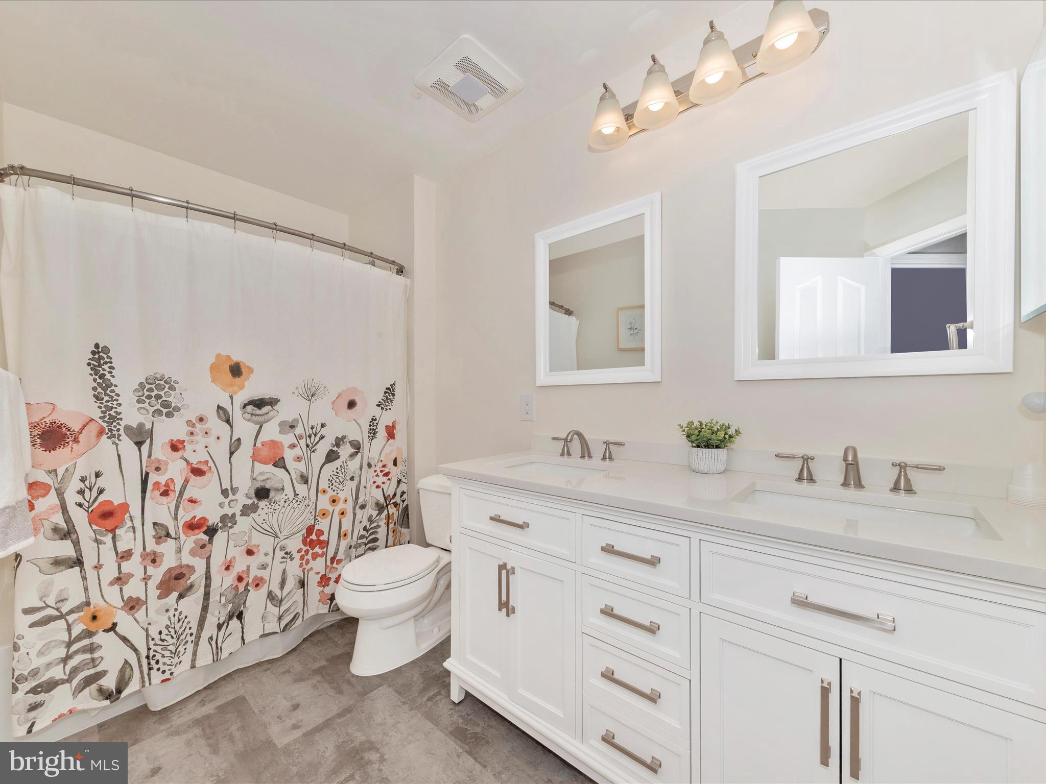 9034 Allington Manor Circle West Frederick, MD 21703 - Photo 27 of 55 a bathroom with a granite countertop sink a toilet and a mirror