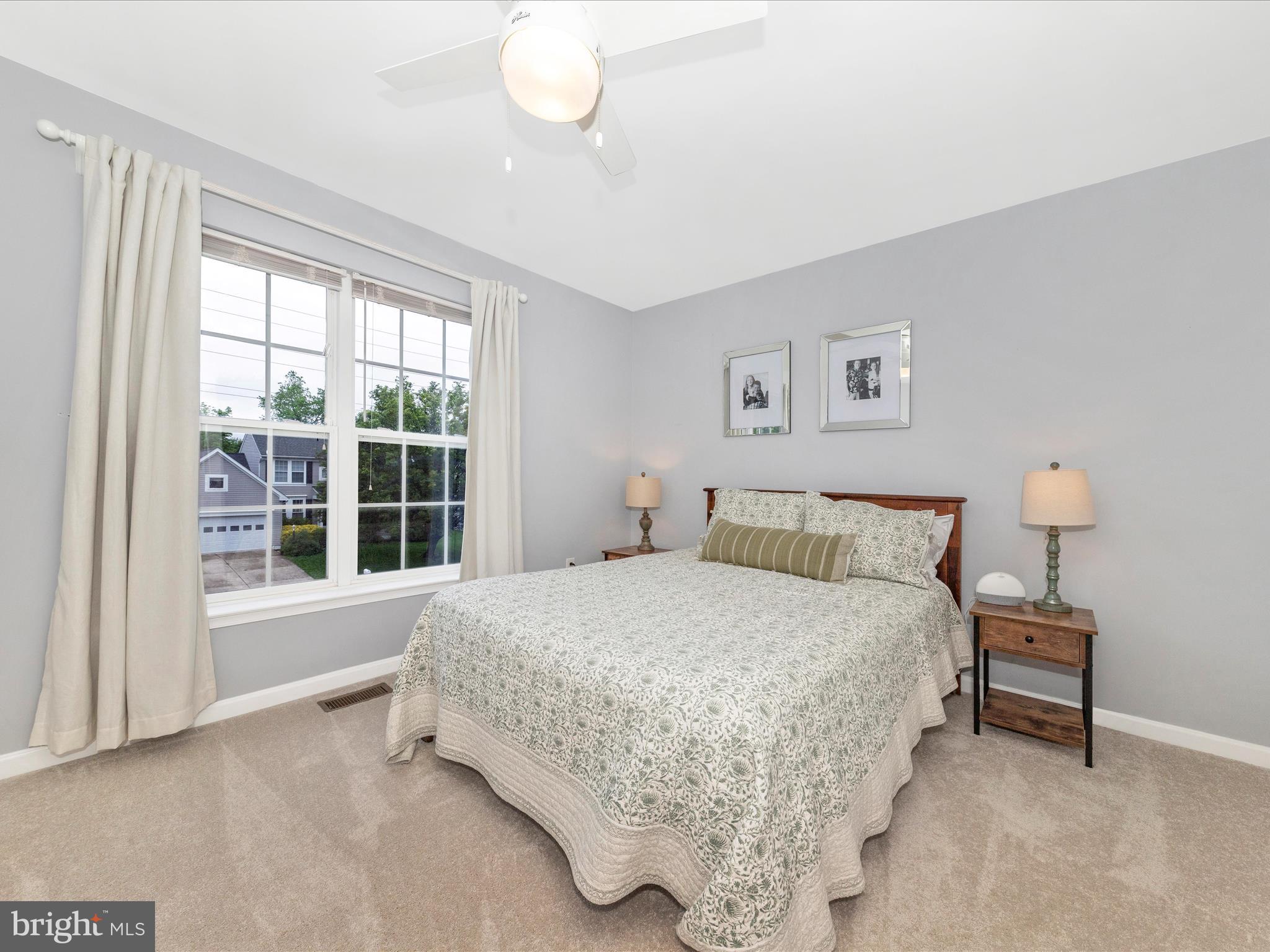 9034 Allington Manor Circle West Frederick, MD 21703 - Photo 31 of 55 a bedroom with a bed lamp and a large window
