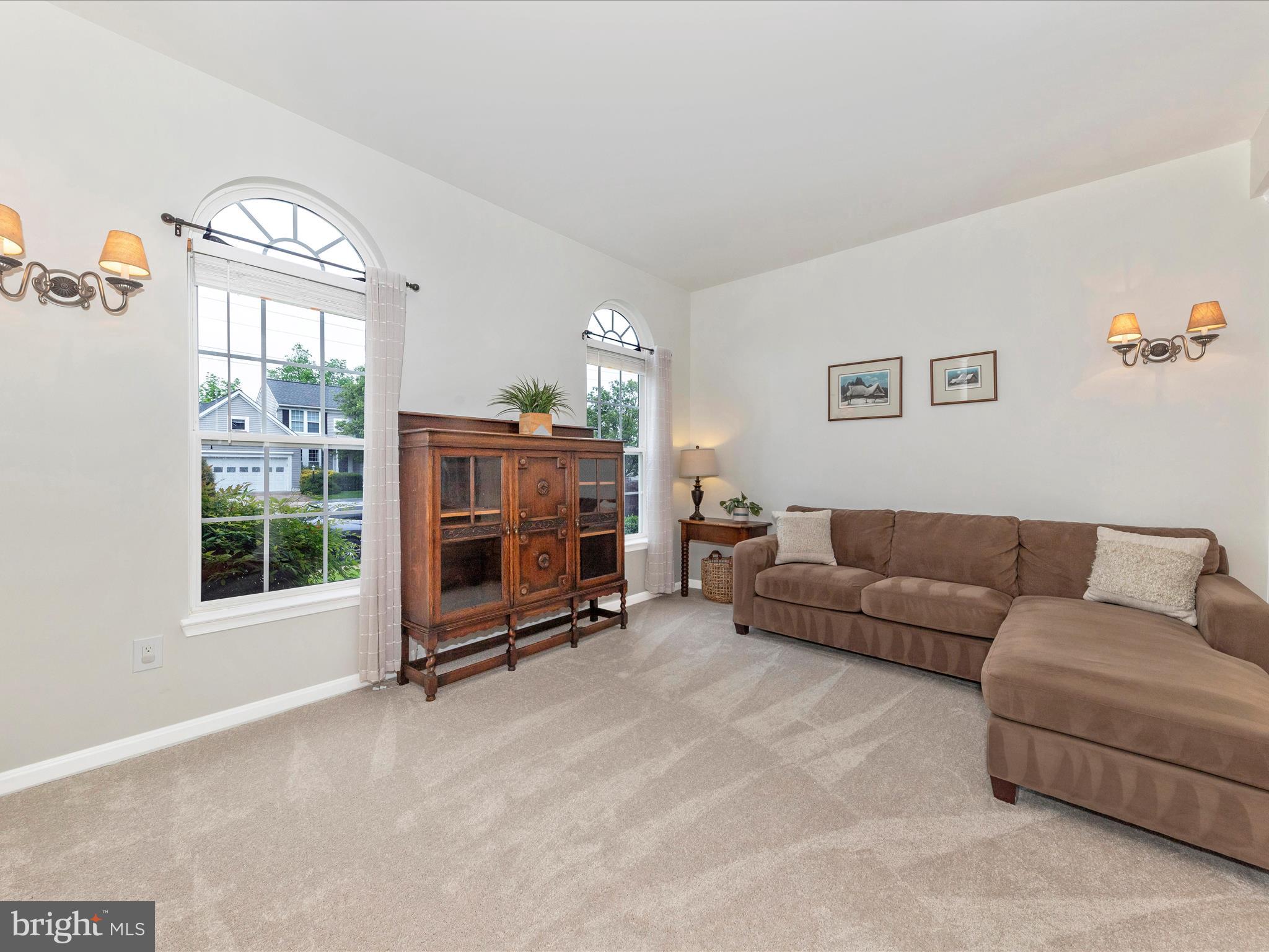 9034 Allington Manor Circle West Frederick, MD 21703 - Photo 4 of 55 a living room with furniture a flat screen tv and a large window
