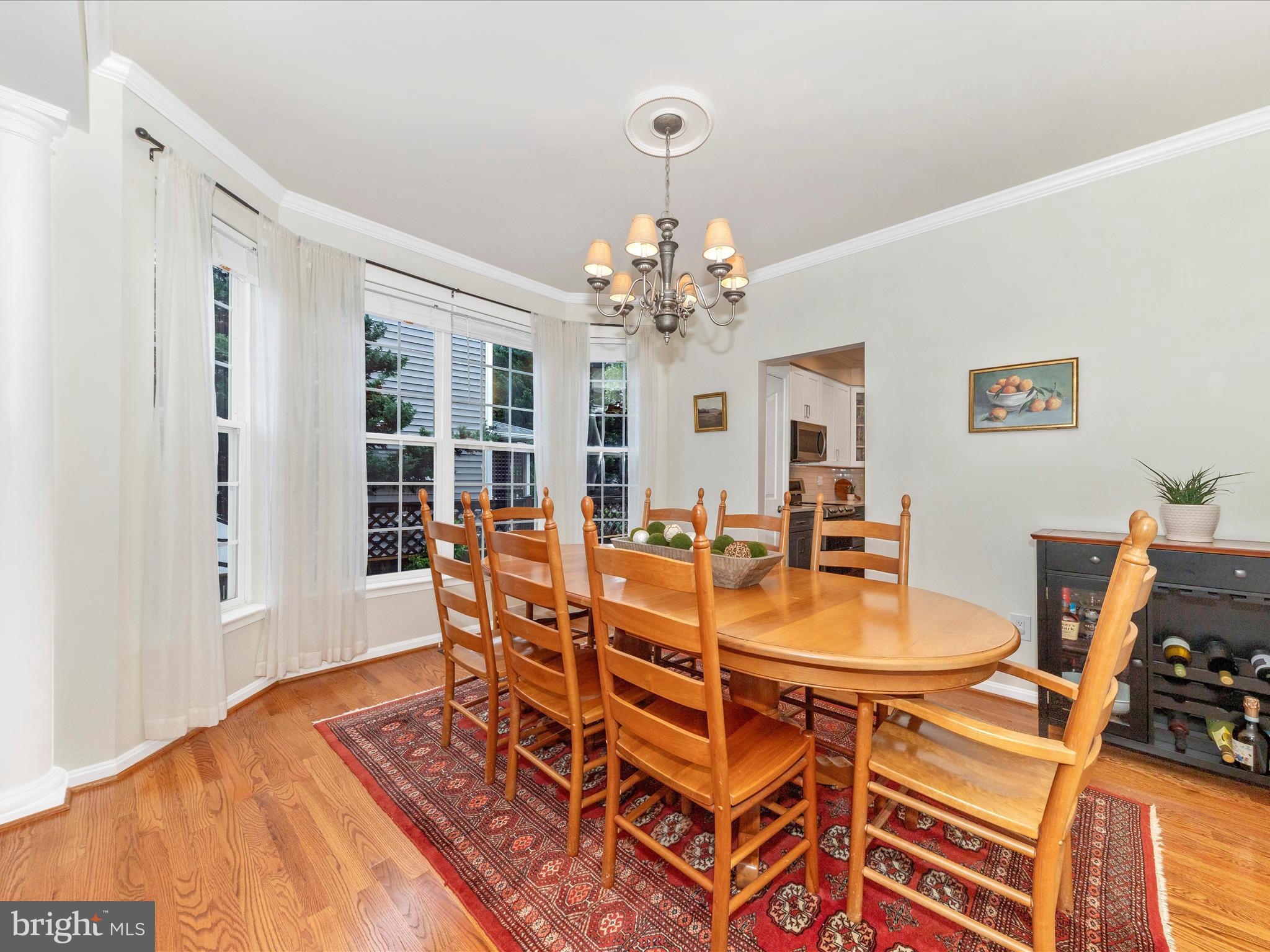 9034 Allington Manor Circle West Frederick, MD 21703 - Photo 5 of 55 a dining room with wooden floor and chandelier