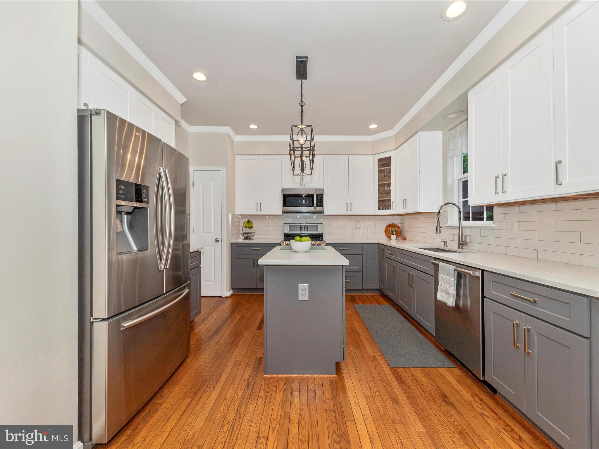 9034 Allington Manor Circle West Frederick, MD 21703 - Photo 7 of 55 a kitchen with stainless steel appliances a refrigerator sink and wooden floor