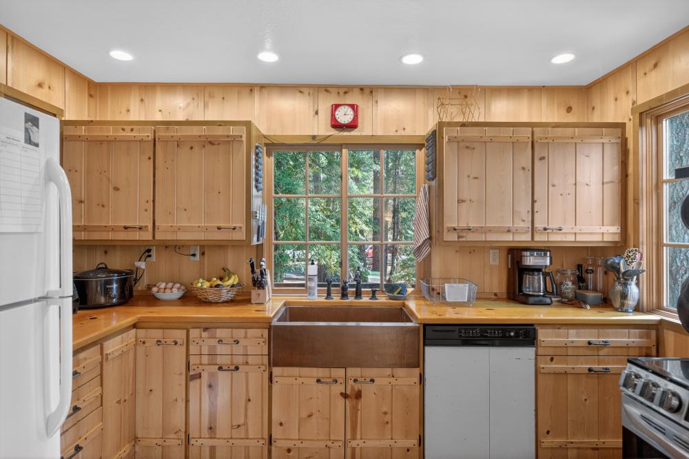 13052 Wood Rose Way Grass Valley, CA 95945 - Photo 13 of 46 a kitchen with stainless steel appliances a sink a stove a refrigerator and cabinets