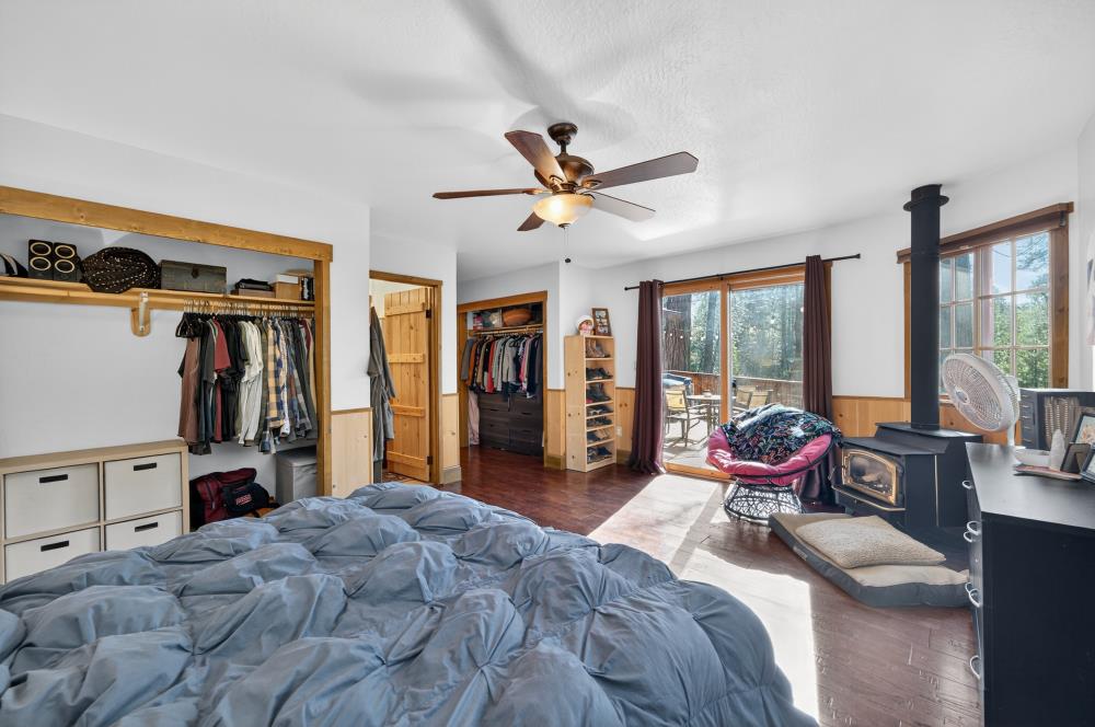13052 Wood Rose Way Grass Valley, CA 95945 - Photo 24 of 46 a bed room with bed and large windows