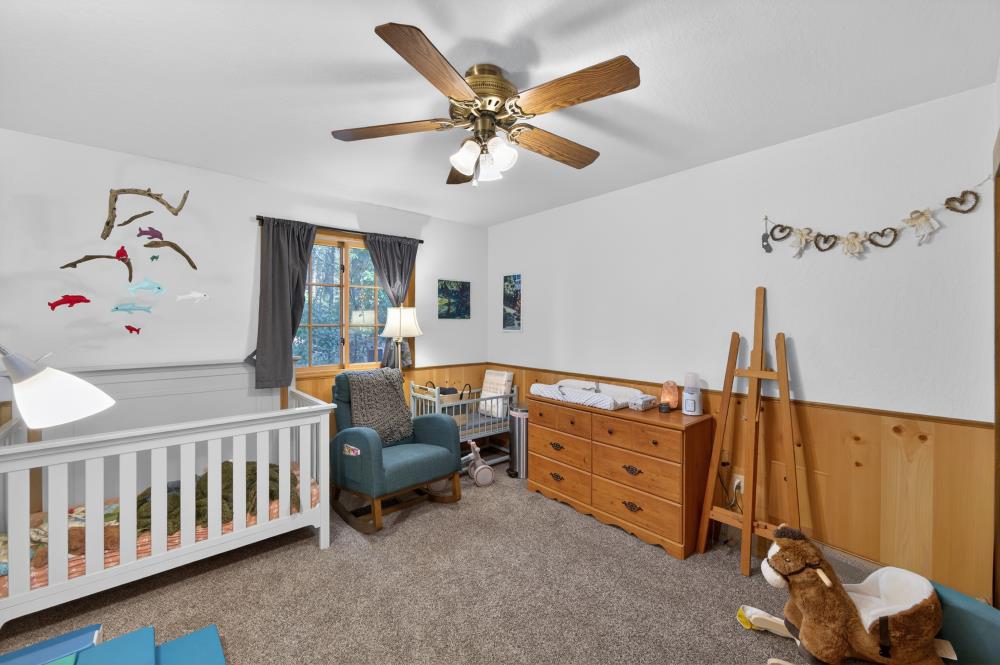 13052 Wood Rose Way Grass Valley, CA 95945 - Photo 27 of 46 a bedroom with furniture and a window