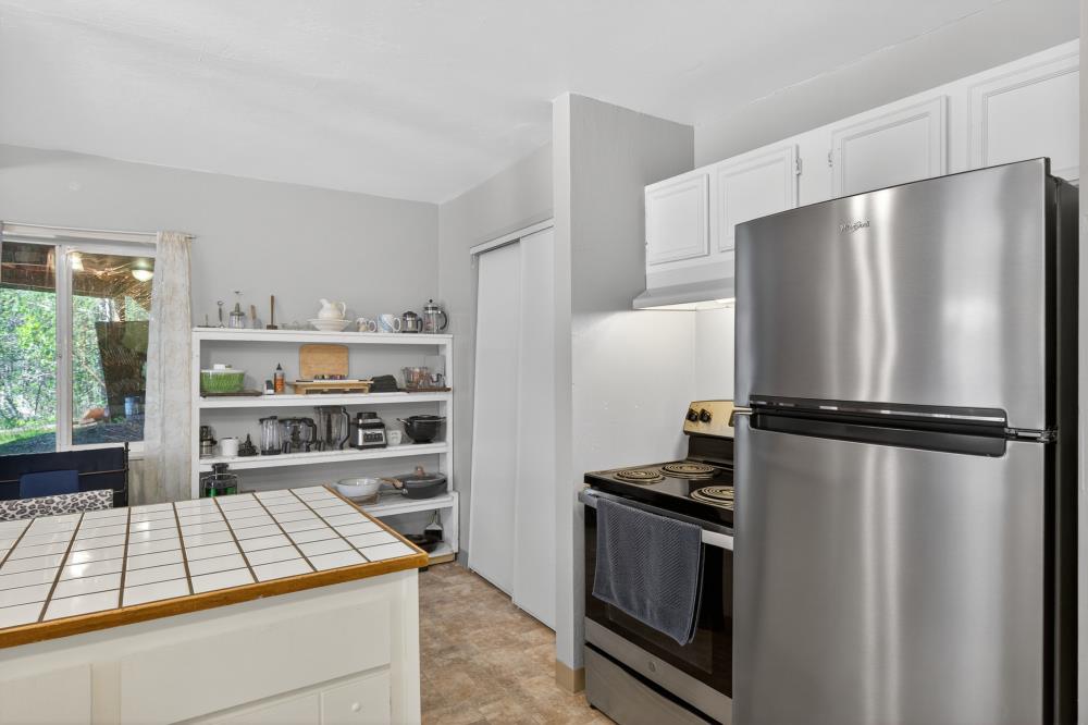 13052 Wood Rose Way Grass Valley, CA 95945 - Photo 33 of 46 a kitchen with stainless steel appliances a refrigerator a stove a sink and a cabinets