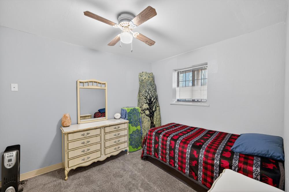 13052 Wood Rose Way Grass Valley, CA 95945 - Photo 34 of 46 a bedroom with a bed and a chandelier