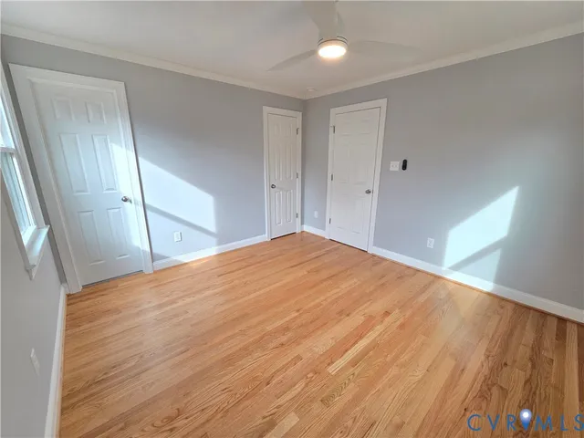 a view of empty room with wooden floor