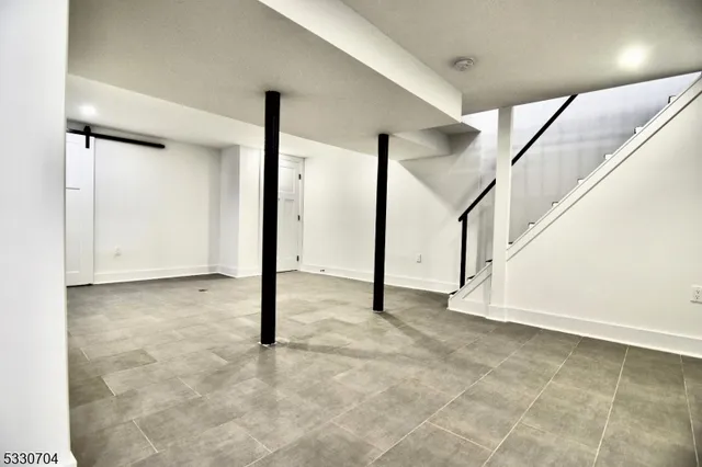 a view of an empty room with stairs