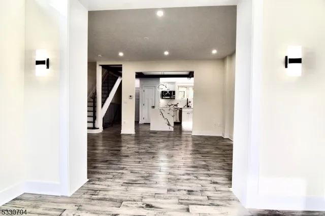a view of a hallway with the view of living room and dining room