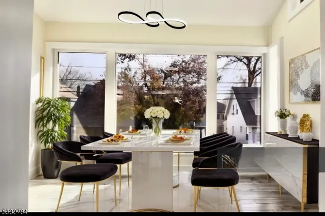 a dining room with furniture and a floor to ceiling window