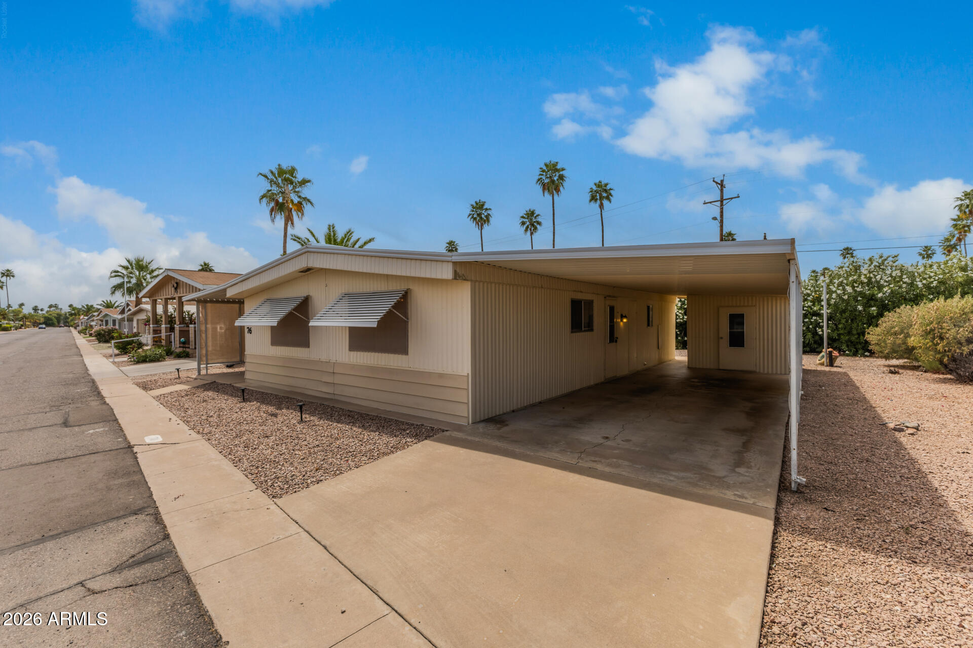3104 East Broadway Road, Unit 76 Mesa, AZ 85204 - Photo 3 of 26 a view of a house with a yard