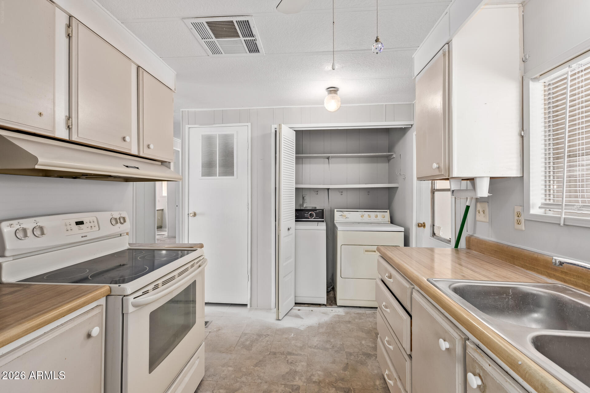 3104 East Broadway Road, Unit 76 Mesa, AZ 85204 - Photo 8 of 26 a kitchen with a sink stove top oven and cabinets