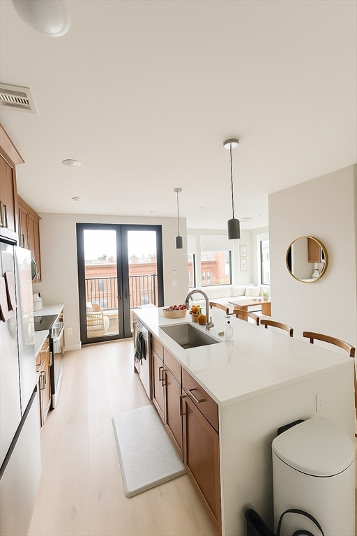 400 West Broadway, Unit 505 Boston, MA 02127 - Photo 3 of 18 a kitchen with a stove a sink and a refrigerator