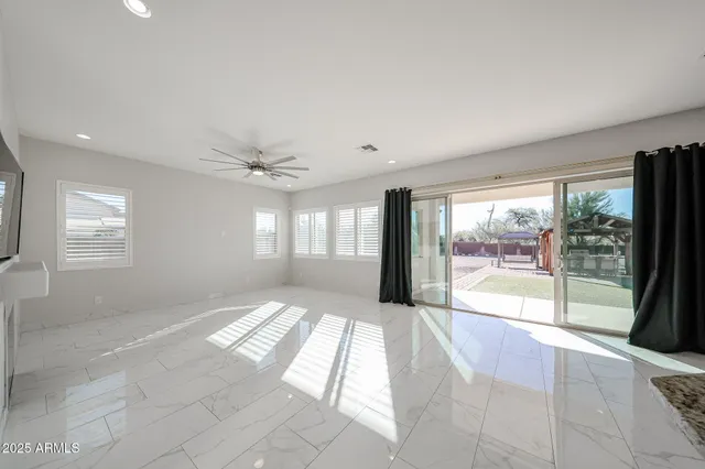 a view of an empty room with a fireplace and a large window