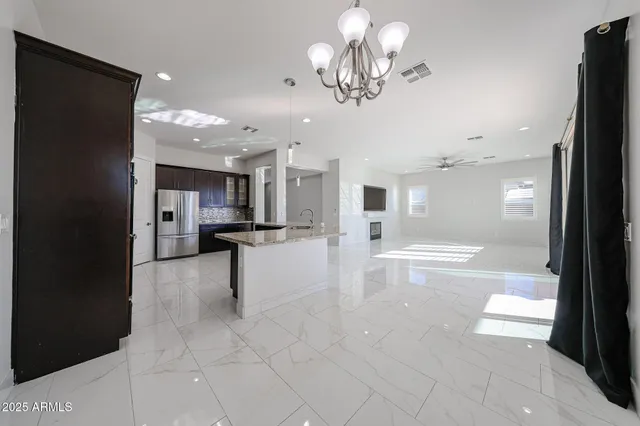a view of a kitchen with a sink and a refrigerator