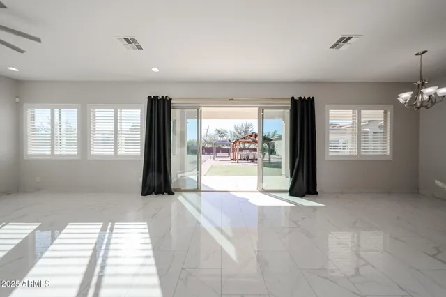 a view of an empty room with a fireplace and a window