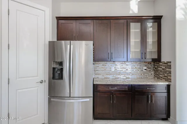 a kitchen with granite countertop a refrigerator and a sink