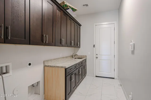a utility room with a sink a washer and dryer