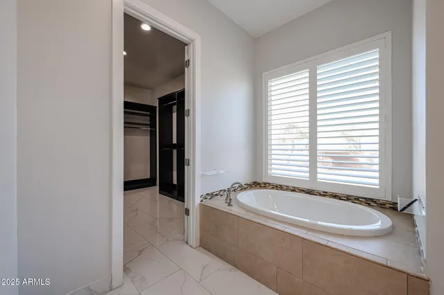 a bathroom with a granite countertop double vanity sink and a mirror