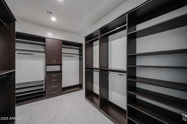 a view of an empty room with a kitchen