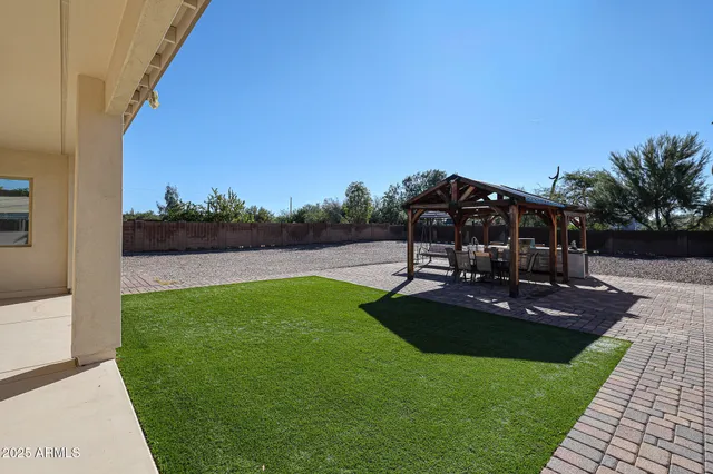 a view of a patio with wooden floor a yard tables and chairs