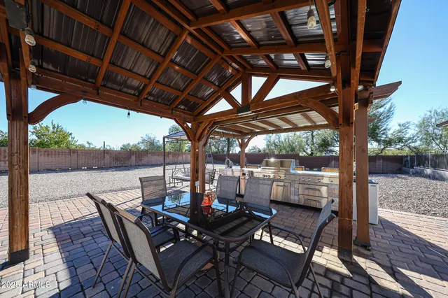 a open kitchen with stainless steel appliances granite countertop a sink a stove and a wooden floors
