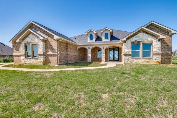 a front view of a house with a yard