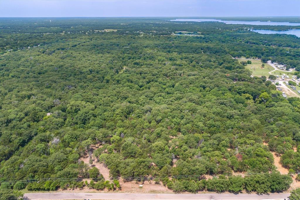 4423 County Road 3706 Wills Point, TX 75169 - Photo 2 of 13 a view of a lush green forest with trees and houses