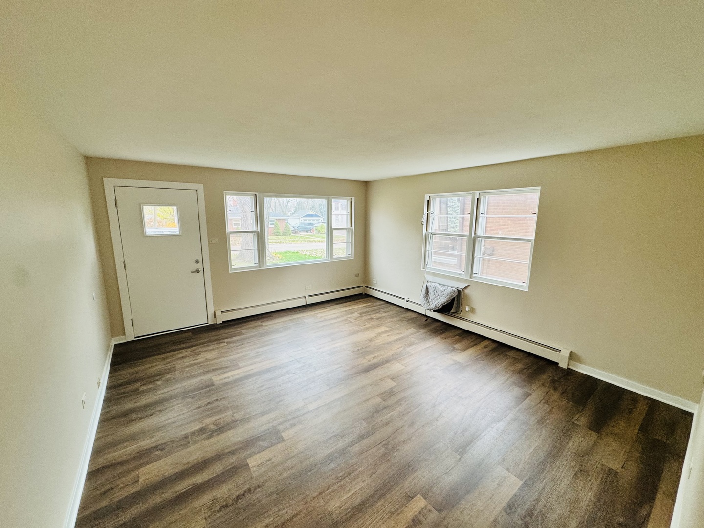 1009 Victoria, Unit 1N Antioch, IL 60002 - Photo 2 of 7 an empty room with wooden floor and windows