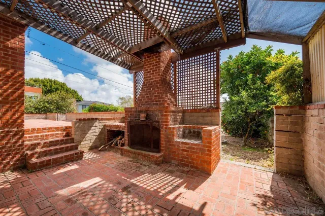 a view of a patio with table and chairs with wooden floor and fence