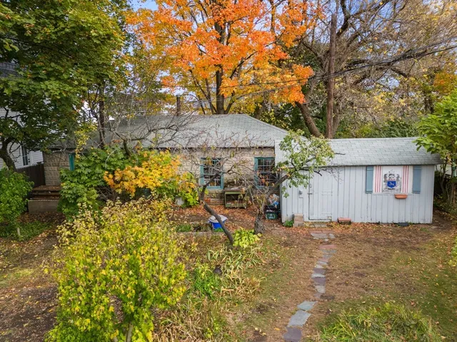 a view of a house with a tree and a yard