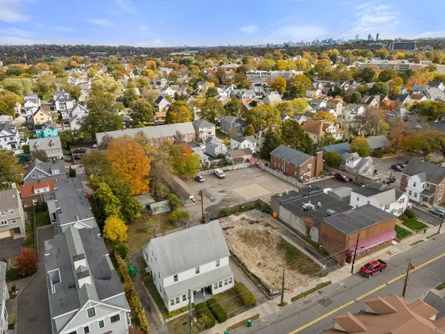 an aerial view of residential houses with outdoor space