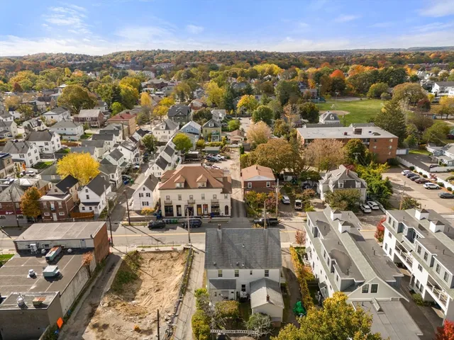 an aerial view of residential building with parking
