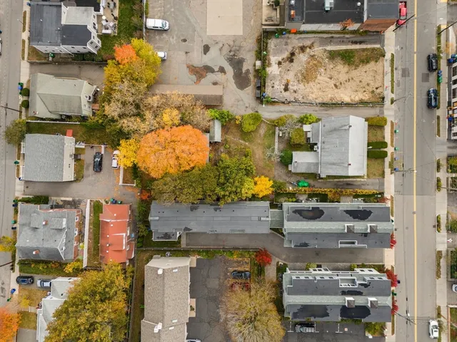 an aerial view of residential houses with outdoor space