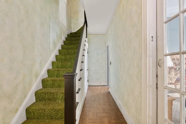 a view of a hallway with wooden floor and entryway