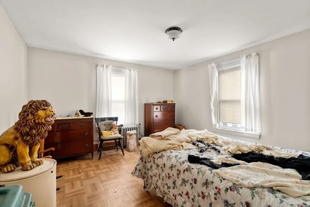 a bedroom with a bed and window