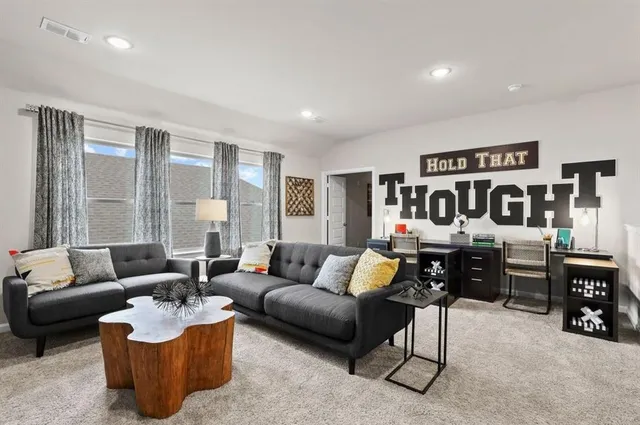 a living room with furniture and large window