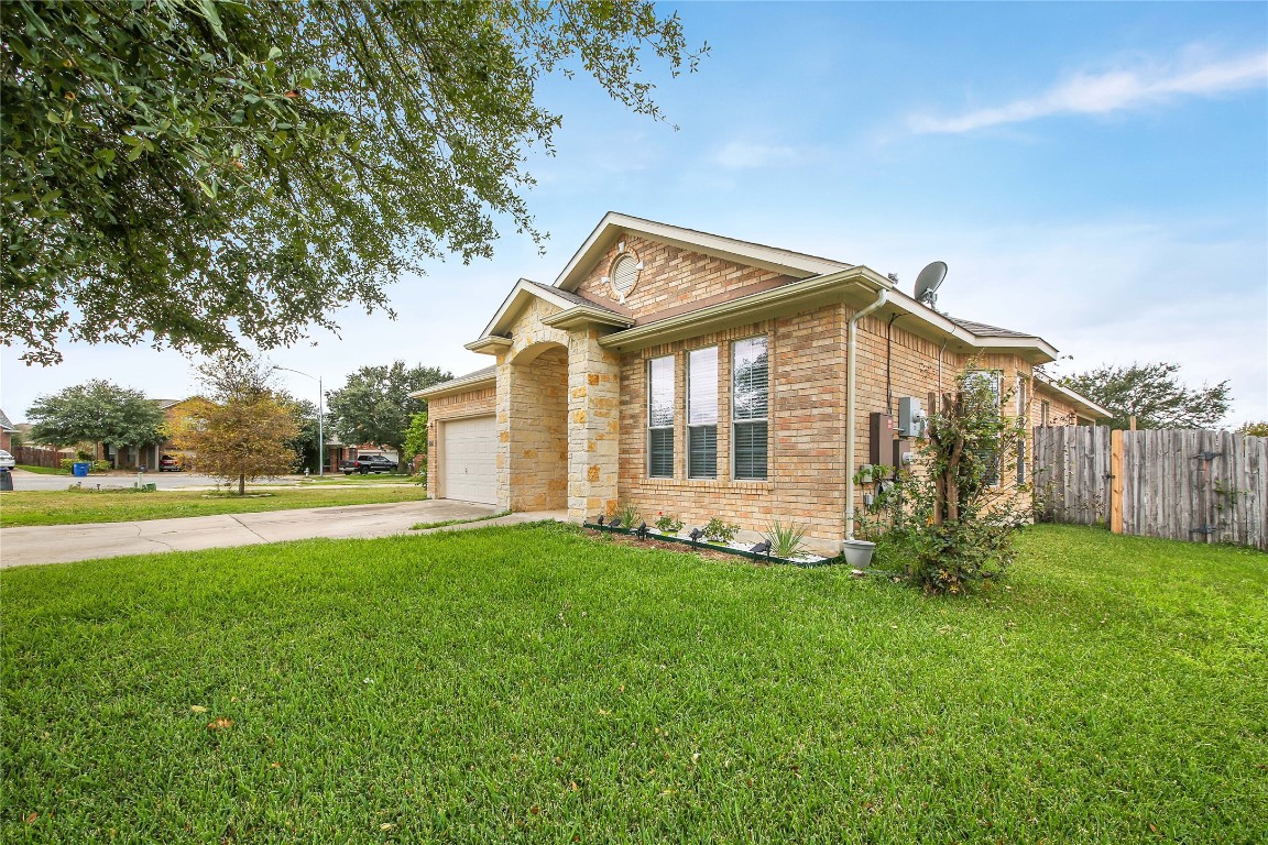 a front view of house with yard and green space
