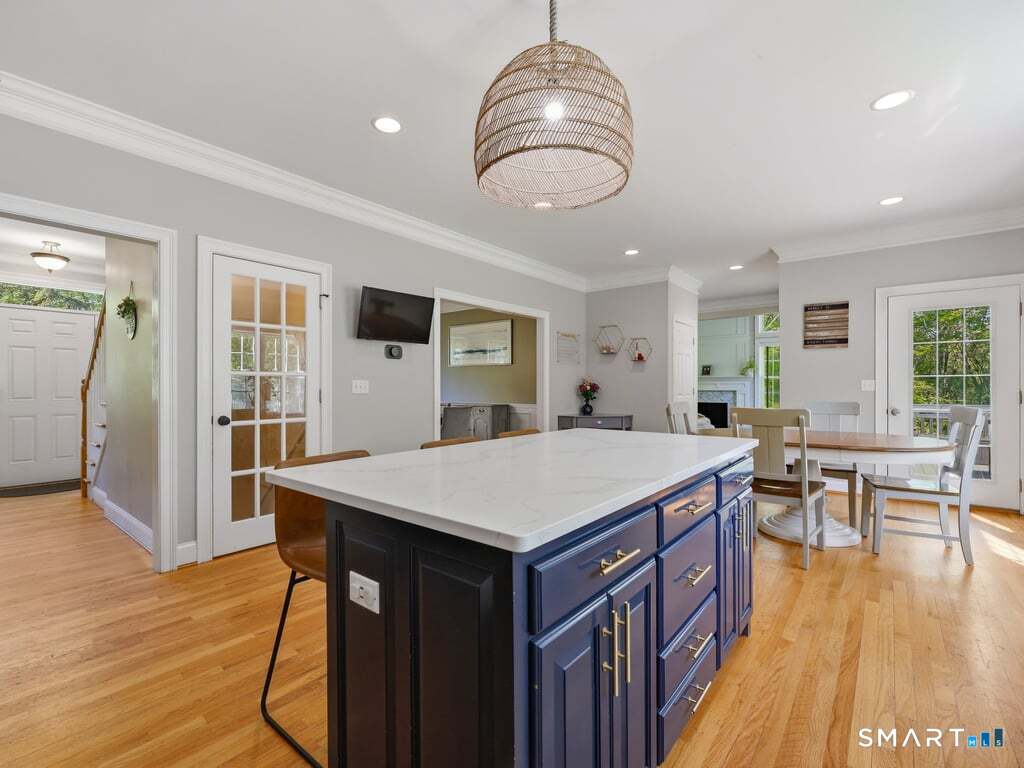 15 Fox Ridge Lane Hebron, CT 06248 - Photo 15 of 40 Amazing updated eat in kitchen with large island, quartz countertops, and wood floors open to the family room and dining room!