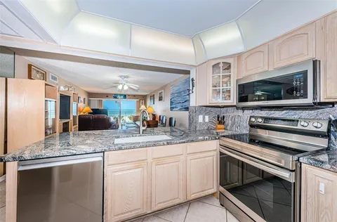 a kitchen with stainless steel appliances white cabinets and a sink