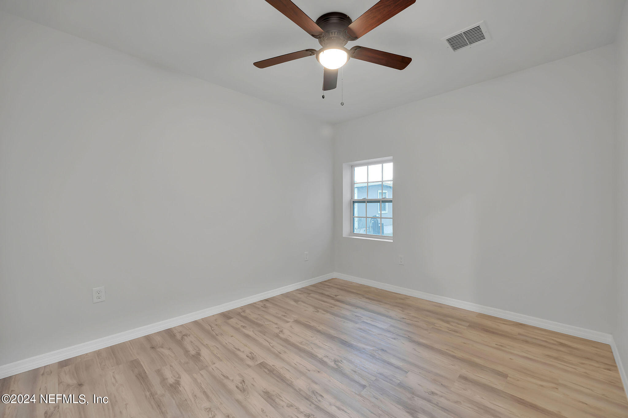 7519 Birdies Road Jacksonville, FL 32256 - Photo 12 of 24 wooden floor in an empty room with a window