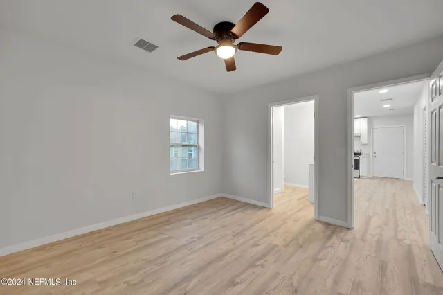 wooden floor in an empty room with a window