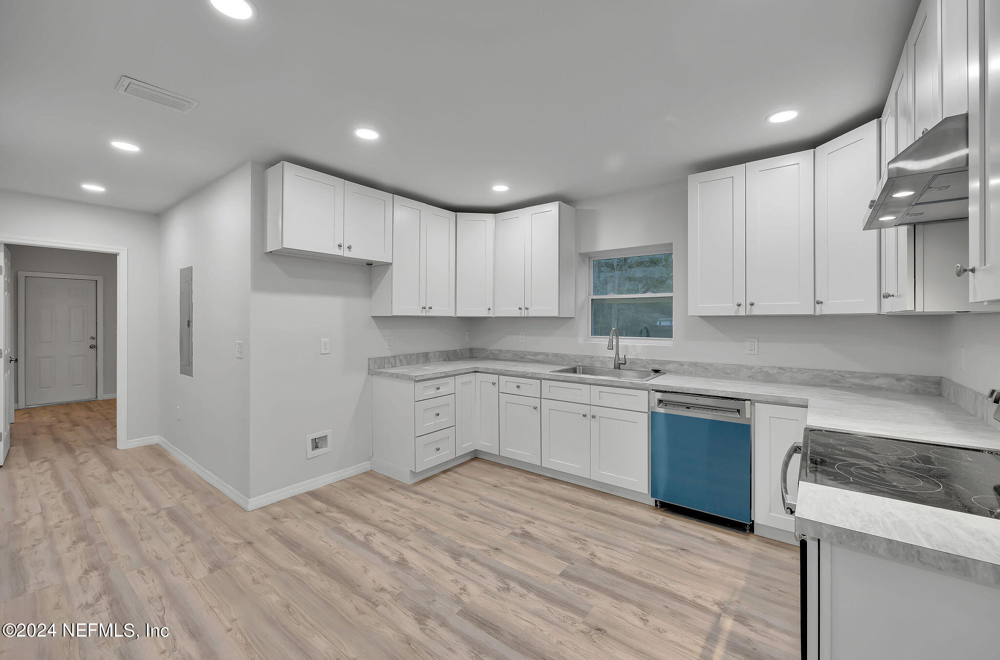 7519 Birdies Road Jacksonville, FL 32256 - Photo 7 of 24 a kitchen with granite countertop white cabinets and white appliances